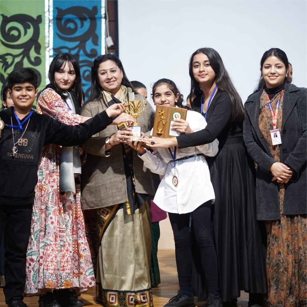 Students celebrating victory with medals at Odyssey of the Mind creative problem-solving competition