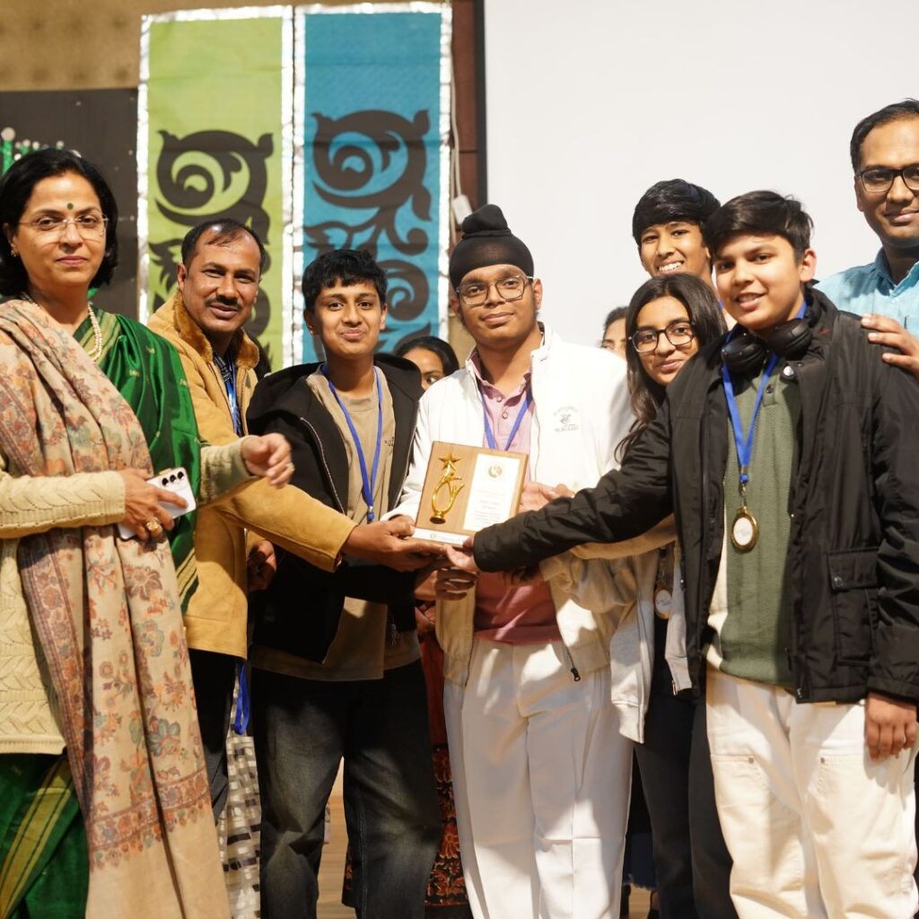 Students and mentors cheering together with medals and awards