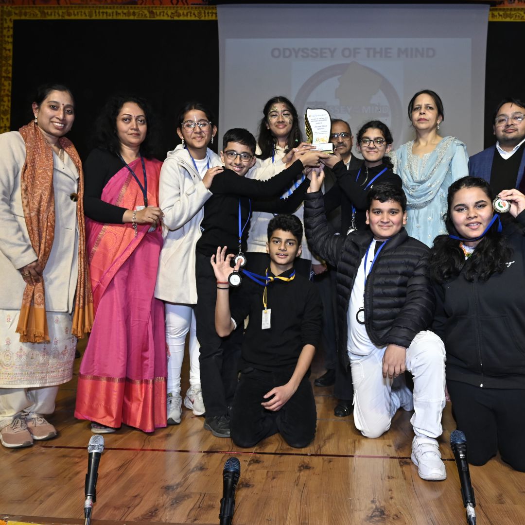 Students celebrating with medals at Odyssey of the Mind event